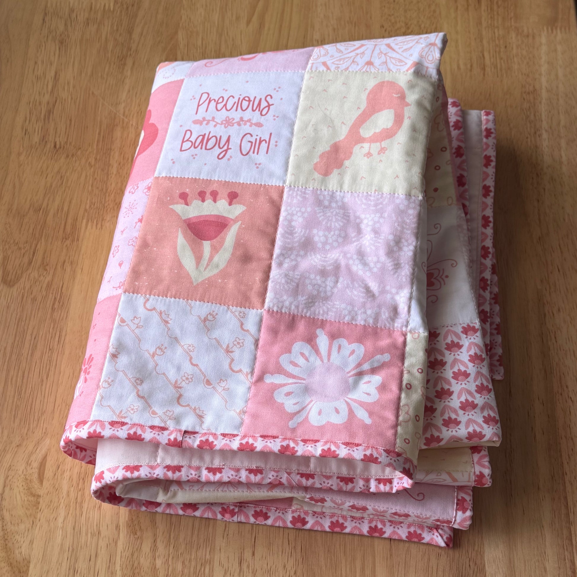 Folded Quilt on Wooden Table